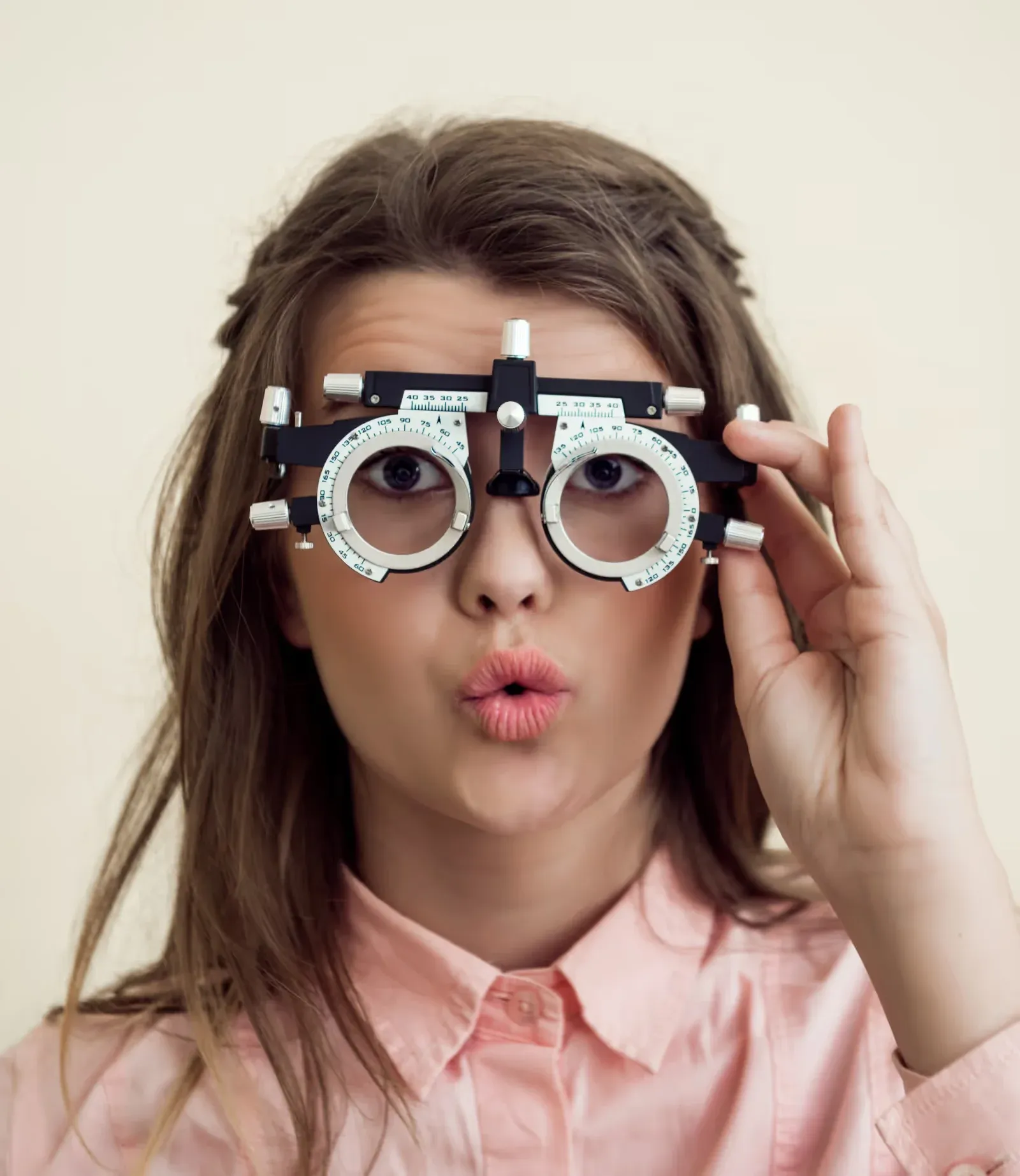 An optometrist adjusting a phoropter during an eye examination